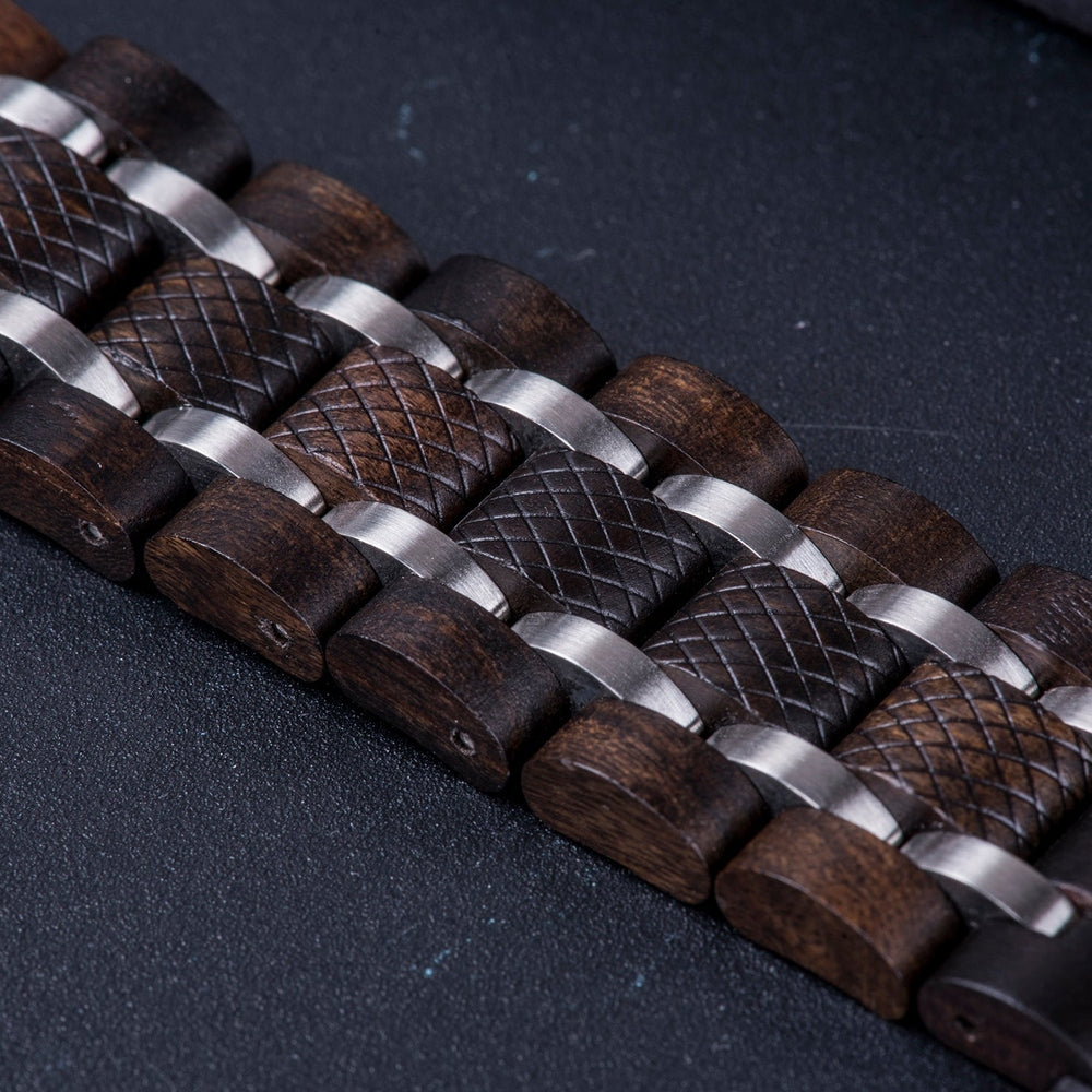 Close-up of a men's wooden watch band with silver metallic links and textured wood segments, showcasing craftsmanship and durability on a dark background.