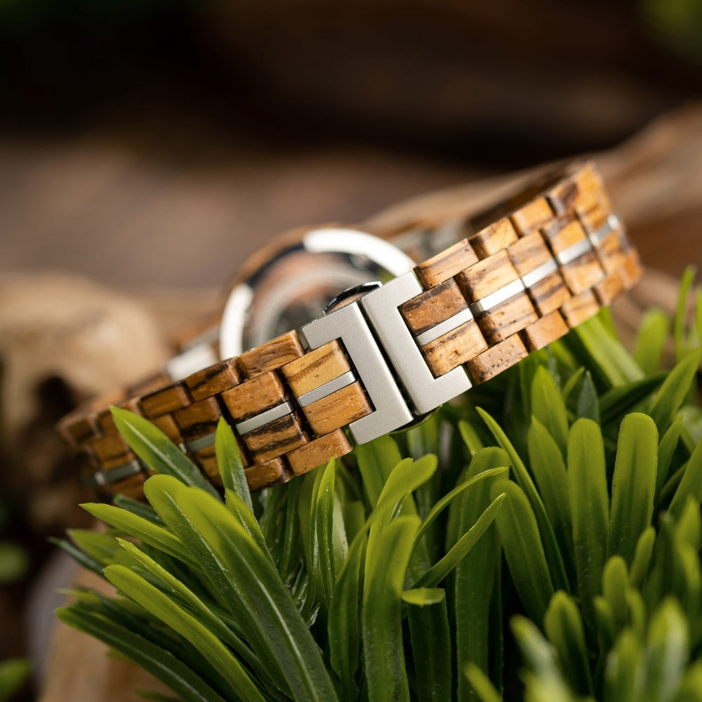 Close-up of Mokozai wooden watch clasp, showcasing the intricate natural wood grain strap and stainless steel clasp, surrounded by vibrant greenery for a natural, eco-friendly aesthetic. This luxury timepiece is crafted with sustainable materials, ideal for nature-loving individuals in Australia.