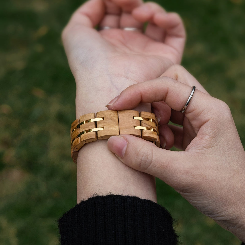 Adjusting Mokozai wooden watch clasp on wrist, showcasing the eco-friendly design and gold accents. Perfect for Australians seeking sustainable, natural wood accessories with a touch of elegance and style.