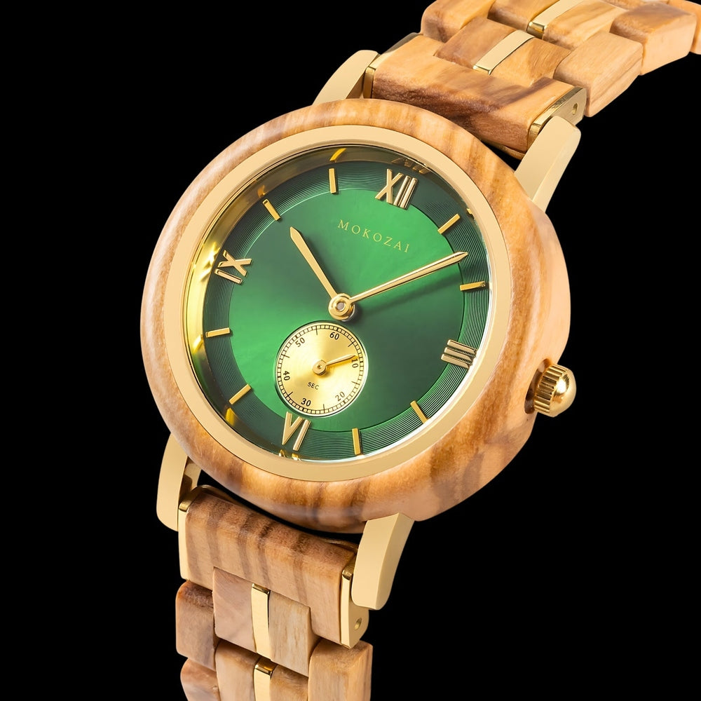 Close-up of Mokozai wooden wristwatch featuring a striking green dial, Roman numeral markers, and gold accents, complemented by a natural wooden bracelet with polished gold elements, set against a black background to highlight its luxurious design and craftsmanship.
