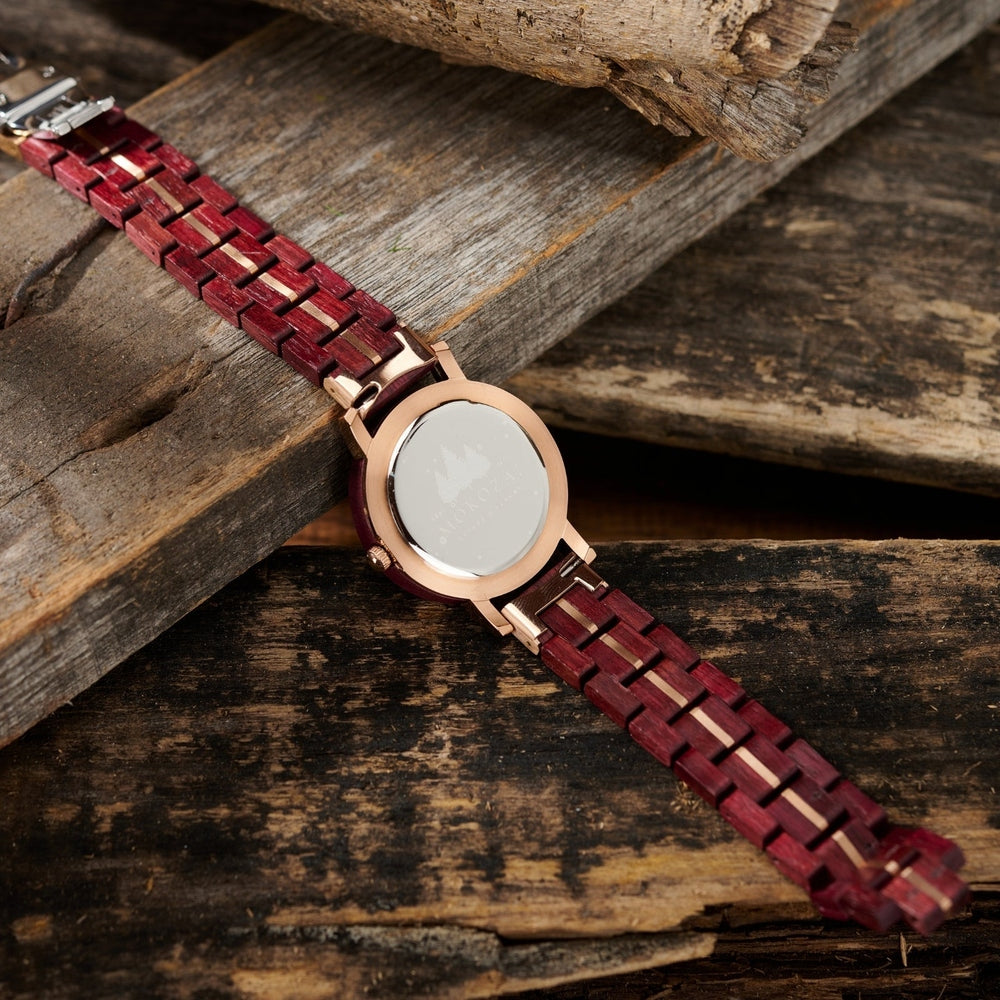 Back view of a Mokozai wooden watch featuring a vibrant purple wood strap and rose gold case, laid on a rustic wooden surface. The stainless steel case back adds a sleek finish, highlighting the intricate craftsmanship and premium materials used in this eco-conscious timepiece, perfect for environmentally aware shoppers in Australia.