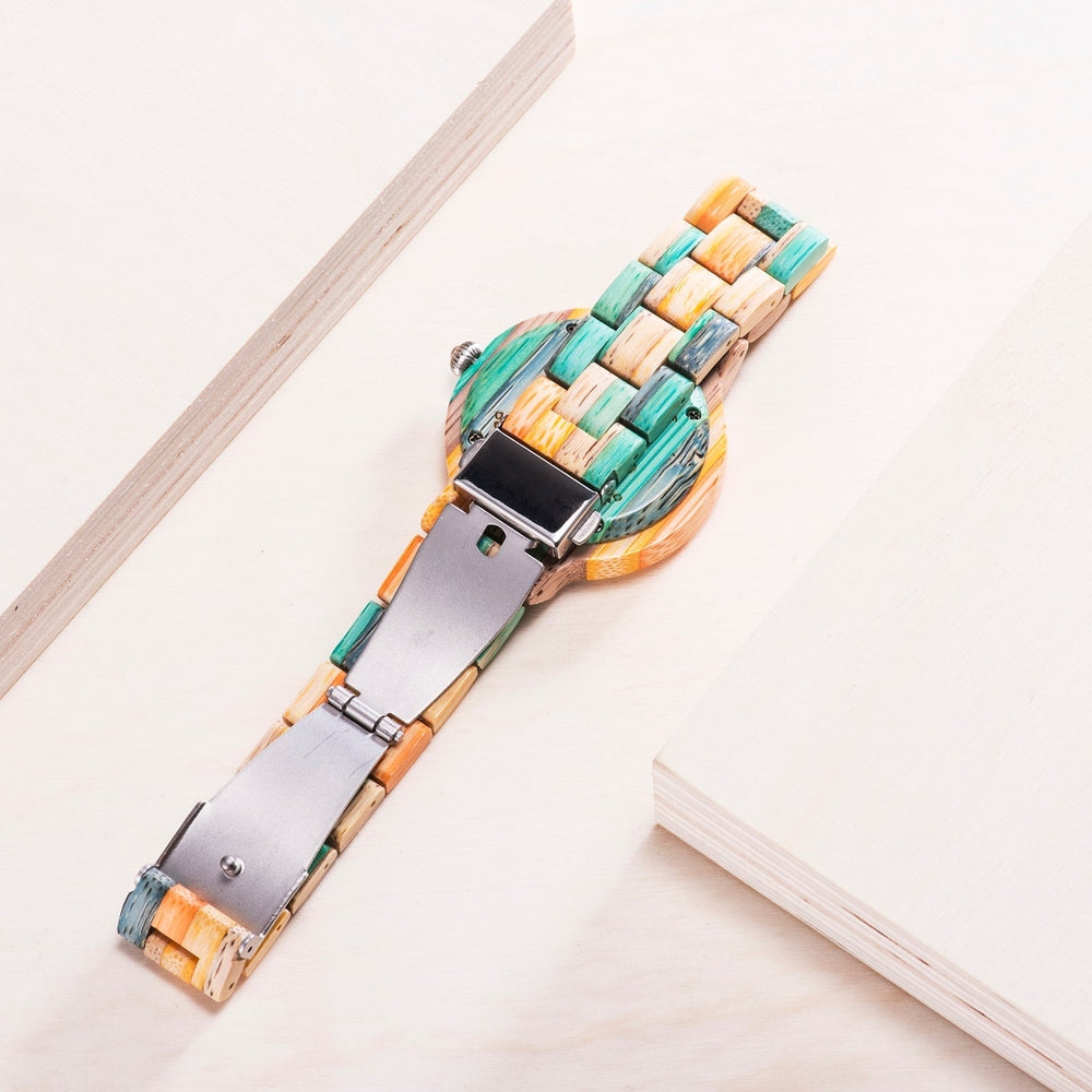Back view of a Mokozai bamboo wristwatch showcasing a multicolored band in shades of teal, orange, and natural bamboo. The silver clasp mechanism adds a modern touch, highlighting the unique blend of nature-inspired materials and contemporary design. Perfect for eco-conscious fashion enthusiasts.