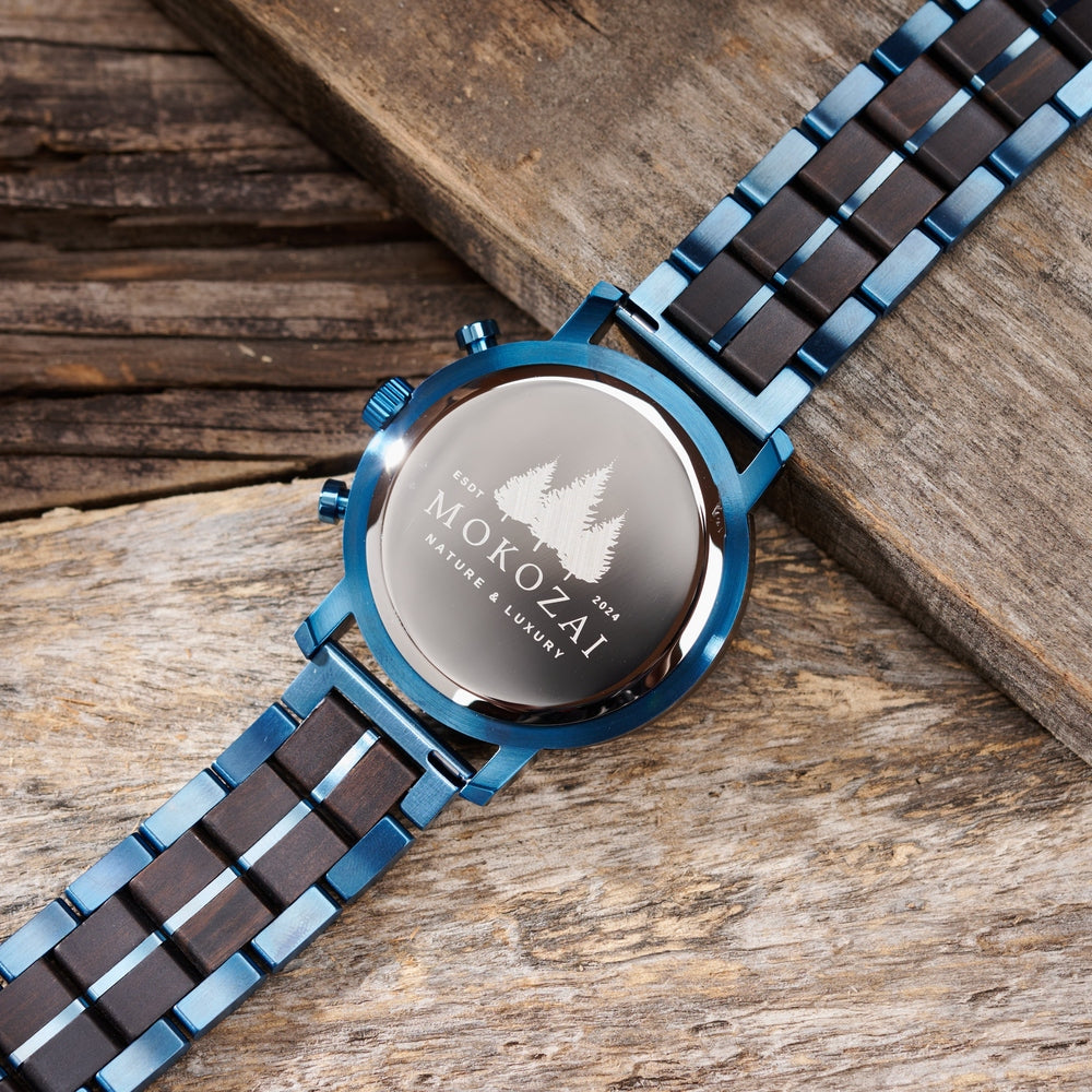 Back view of Mokozai men's chronograph watch showcasing the engraved logo and 'Nature & Luxury' tagline on the polished stainless steel case. The blue and black wood and metal hybrid strap complements the natural wood design, emphasizing the brand's eco-conscious luxury appeal.