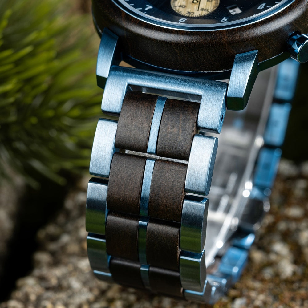 Close-up of a Mokozai watch strap featuring a sleek combination of polished blue metal and dark wood links, showcasing a sophisticated blend of nature and modern craftsmanship.