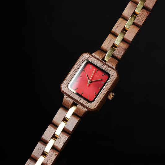 Square-shaped Mokozai wooden wristwatch with a bold red dial and gold accents, featuring a natural wood and gold link strap, displayed against a sleek black background.