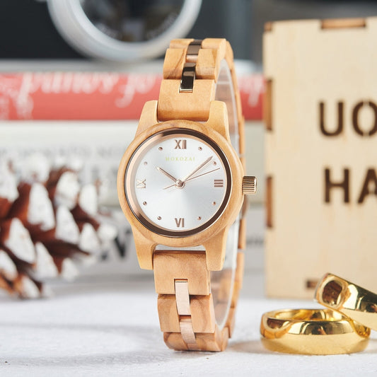 Minimalist Mokozai wooden watch with a sleek silver dial, Roman numerals, and golden accents, displayed beside festive decor. A perfect blend of luxury and nature for Australians seeking eco-conscious elegance.