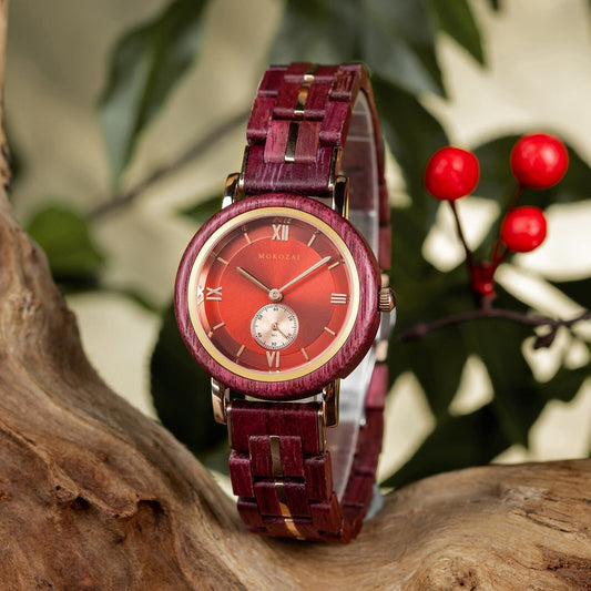 Elegant Mokozai wooden watch with a vibrant red dial and matching red and gold strap, displayed on a natural wood log. The bold Roman numeral markers and sleek subdial add sophistication, appealing to eco-conscious Australians who value luxury and sustainability.