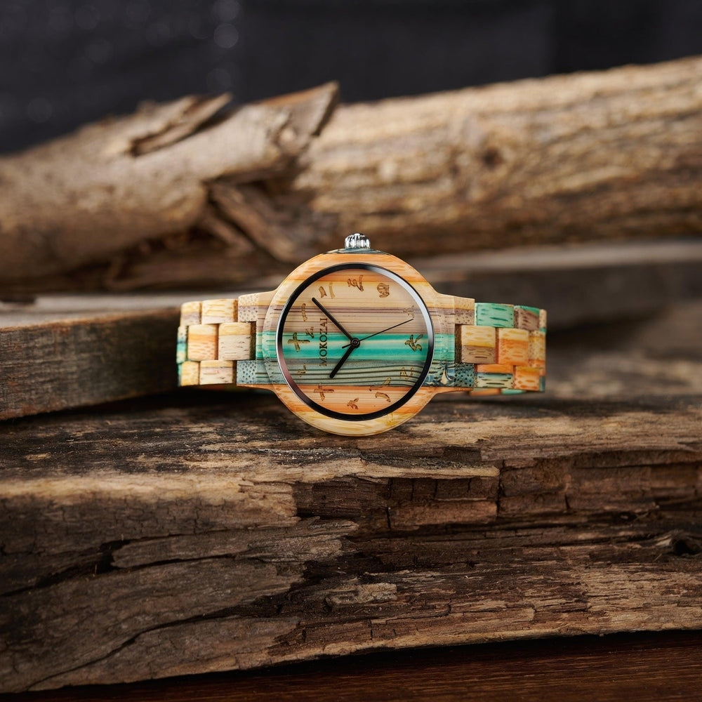 Mokozai bamboo wristwatch with a multicolored dial and band in shades of teal, natural bamboo, and orange. The minimalist watch face features delicate Asian-inspired numerals, offering a harmonious blend of nature and cultural elegance. Set against a rustic wooden backdrop, this eco-friendly timepiece embodies sustainable luxury.