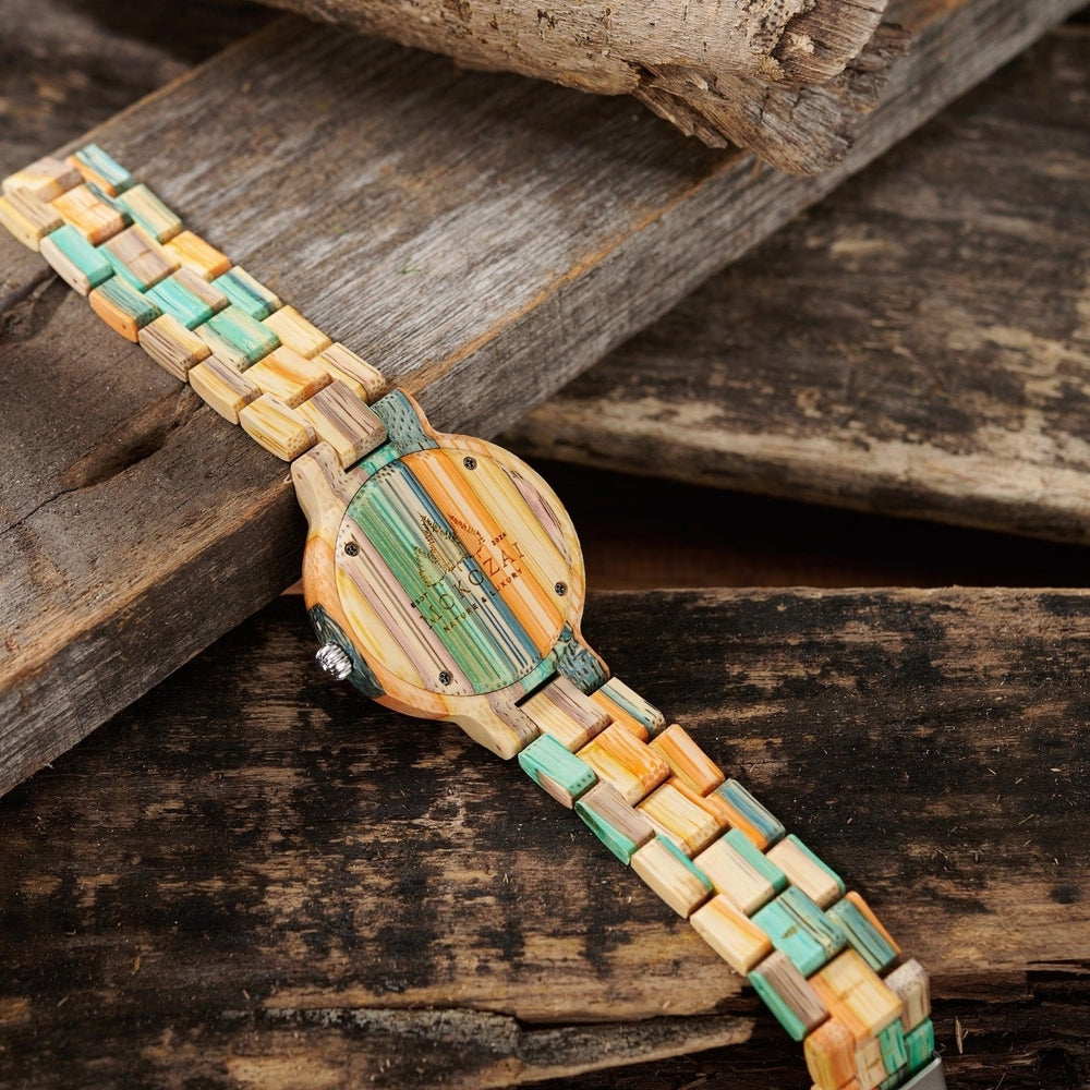 Back view of a Mokozai bamboo wristwatch featuring a vibrant multicolored band with natural, teal, and orange tones. The wooden case back is engraved with the Mokozai logo, emphasizing the brand's commitment to eco-friendly materials and craftsmanship. Perfect for nature-inspired, stylish individuals in Australia.